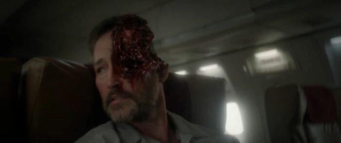 Natalie's dead, with half of his head missing and bloody, on the plane