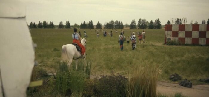 Alex rides a white horse off into a field with Tyler, Elizabeth and the children of the undersea