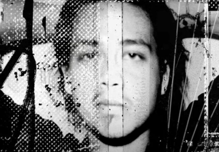 Closeup black and white photo of Chi Cheng the bassist from the Deftones