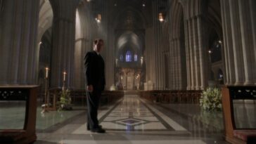 President Bartlet (Martin Sheen) stands in the center of the National Cathedral looking back over his shoulder