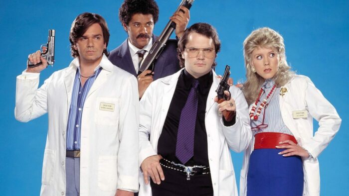 Characters hold guns and stand in a row in Garth Marenghi’s Darkplace