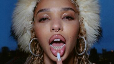 FKA Twigs slays on the cover of her Caprisongs mixtape, showing off her hoop earrings, septum piercing and fur hat against a twilight background