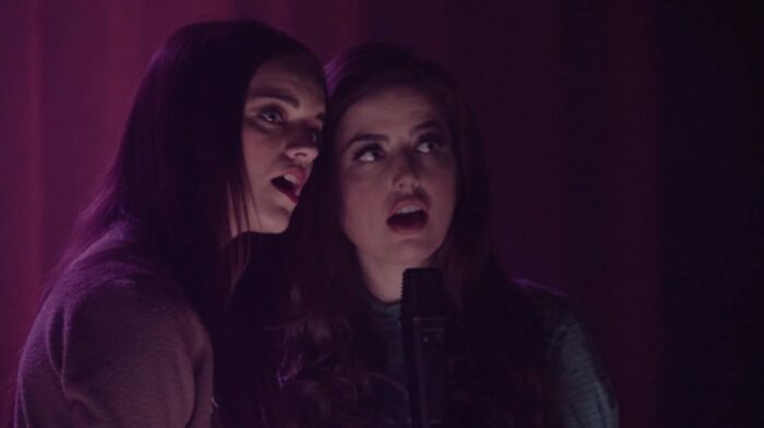 Two female backup singers sing into a microphone in Part 13 of Twin Peaks: The Return