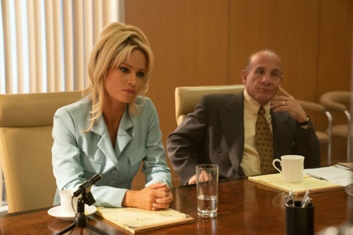 Pam (Lily James) and her lawyer Sandy Alden (Paul Ben-Victor) listen to the other side.