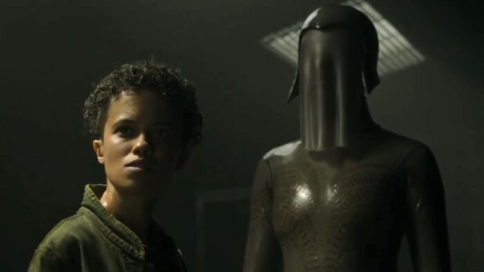 Tempest stands in front of the ancient android, both looking forward