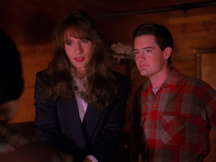 Denise Bryson and Agent Cooper look at Audrey Horne as Denise shakes her hand