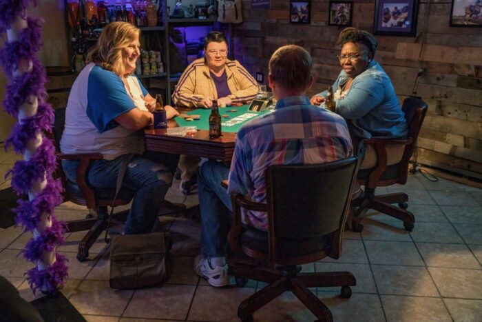 Sam, Fred, Joel and Tiffani sit around a table playing poker