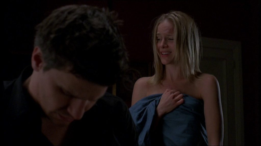 Angel (David Boreanaz) shrugs Darla (Julie Benz) off after spending the night with her.