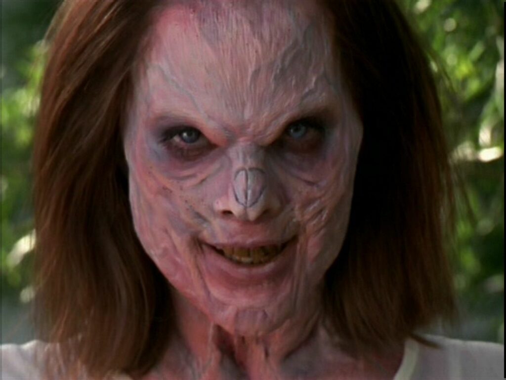 Anyanka (Emma Caulfield) wears a villainous smile on her demonic face. 