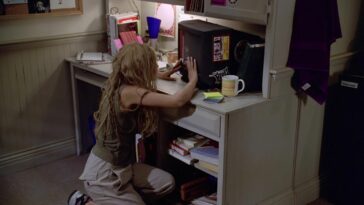 Buffy (Sarah Michelle Gellar) pokes at a turned off television.