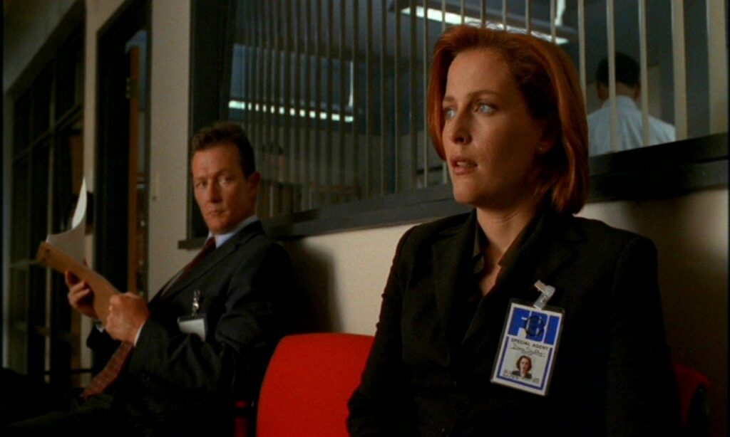 An anxious Agent Scully is being watched by Agent Doggett