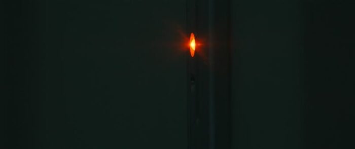 A red light on a metal sensor panel