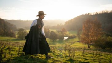 Anne Lister (Suranne Jones) walks across a field.