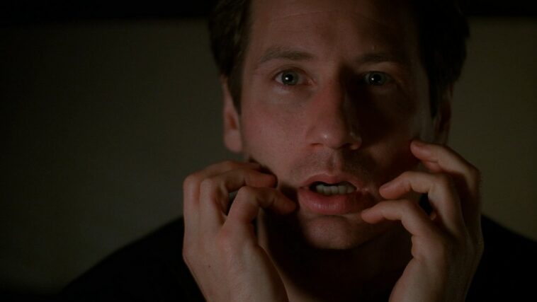 Mulder holds his hands to his face, mouth open