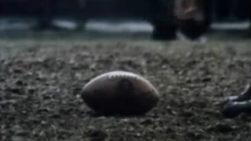 A football rests on a field