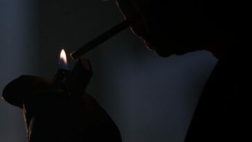 Cigarette Smoking Man lights up a cigarette in the X-Files