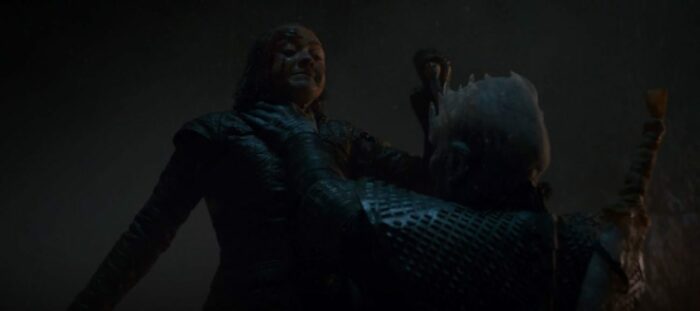 Arya in the air, with the Night King's hand on her throat, holding a knife