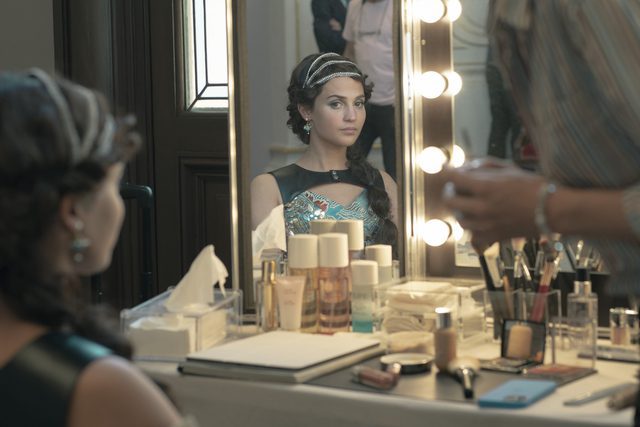 Image from Irma Vep: Alicia Vikander as MIra Harberg, in character as Irma Vep, seated in her dressing room.