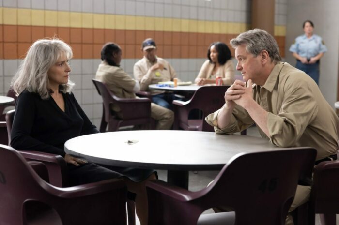 Sophie and Michael sit at a visiting table in prison