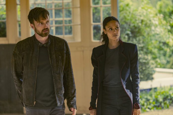 Aaron Paul and Thandie Newton in a barn in Westworld.