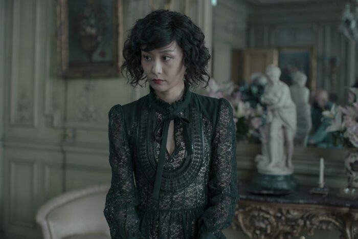 Image from Irma Vep: Cynthia Keng (Fala Chen), sitting in a lavish suite.
