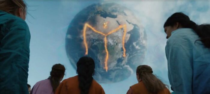 A fiery M type symbol on the face of the Earth over Africa, as Mooners look up at it