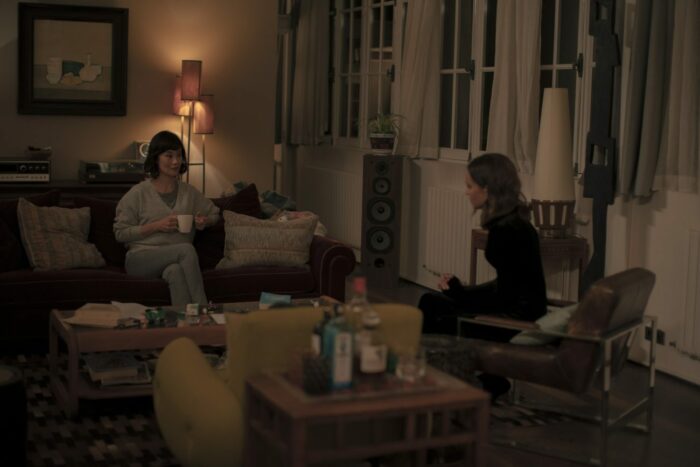 Image from Irma Vep: Jade (Vivian Wu) and Mira (Alicia Vikander) sit in an apratment.