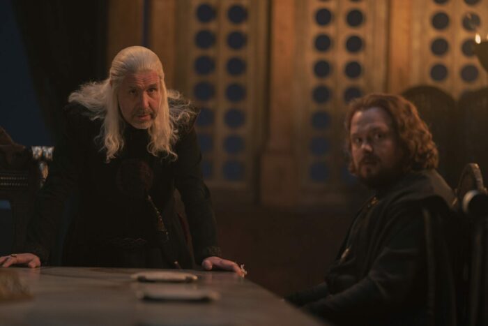 Viserys hunches over a table, looking forward in House of the Dragon S1E2