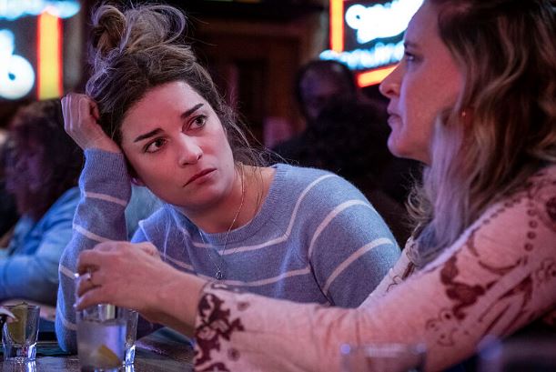 Allison rests her head on her right hand as she sits at a bar with Diane