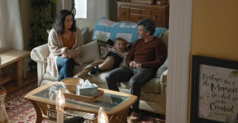 Nathan, Angela and Adam sit on the couch