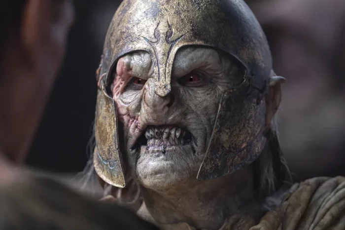 Close up of an orc in a helmet sneering