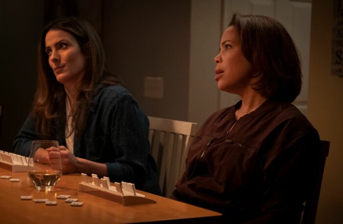 Tammy looks to the side at another woman while playing Rummikub in Kevin Can F**k Himself S2E3