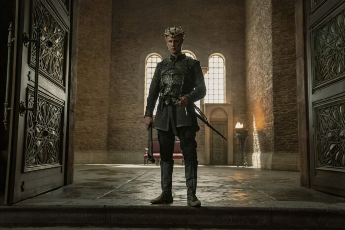 Daemon, standing in the doorway of the great hall wearing a crown