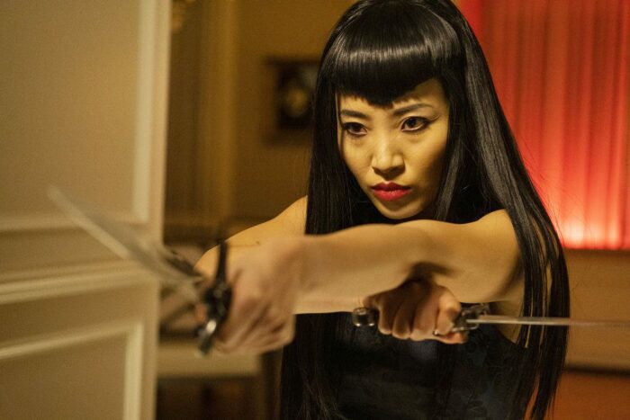 Christin Park as Nikki practising with her knives