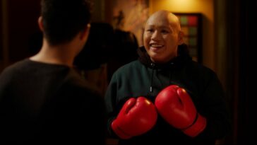 Jacob Batalon as Reginald with boxing gloves on during training with Maurice