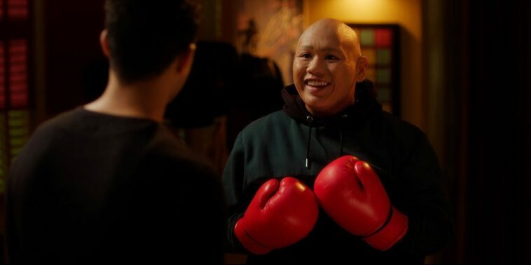 Jacob Batalon as Reginald with boxing gloves on during training with Maurice
