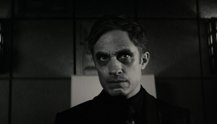 A man dressed in black, in black and white, in Marvel's Werewolf by Night