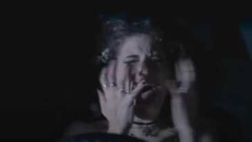 A woman screams with her hands in front of her face in Terrifier 2