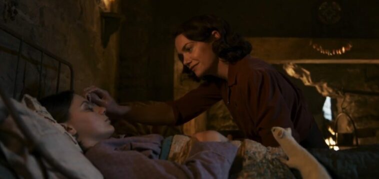 His Dark Materials S3E1 - Lyra lies on a bed asleep while Mrs. Coulter wipes at her forehead with a rag as Pan watches from the bedside