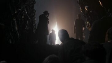 His Dark Materials S3E6 - A bright light shines into a cave full of silhouetted people, as if a curtain has been drawn back to reveal the outside world