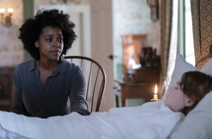 Mallori Johnson as Dana James at the bedside of David Alexander Kaplan as Rufus Weylin