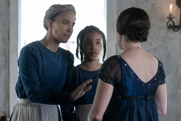 Sophina Brown as Sarah, Lindsey Blackwell as Carrie talking to a white woman who once lived at the Weylin estate