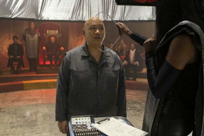 Jacob Battalion as Reginald getting his forehead measured as part of the vampire assessment