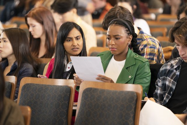 (L-R)Amrit Kaur and Alyah Chanelle Scott in the Bio-Chem lecture when Alyah is handed back the wrong test by the TA