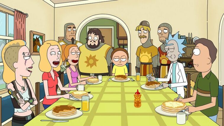 The Smith family is gathered around the dinner table with the Knights standing behind them.