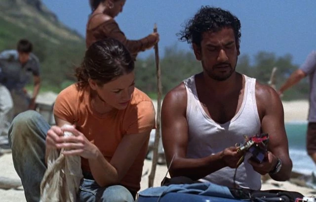Kate and Sayid on the beach looking at his transponder