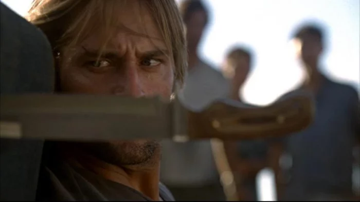 Close up of a knife in front of Sawyer's face
