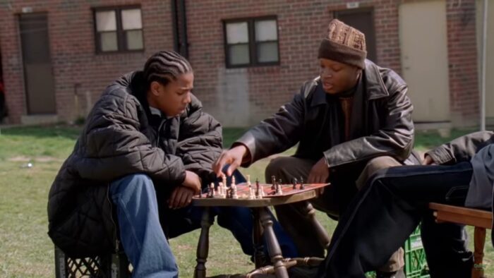 D'Angelo and Wallace in the projects at a chessboard