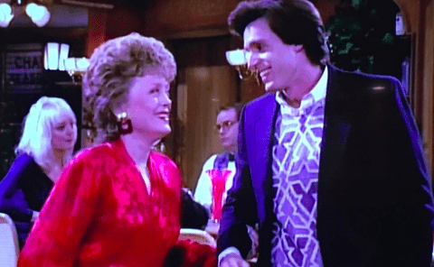 Blanche excitedly discusses something with a handsome young man