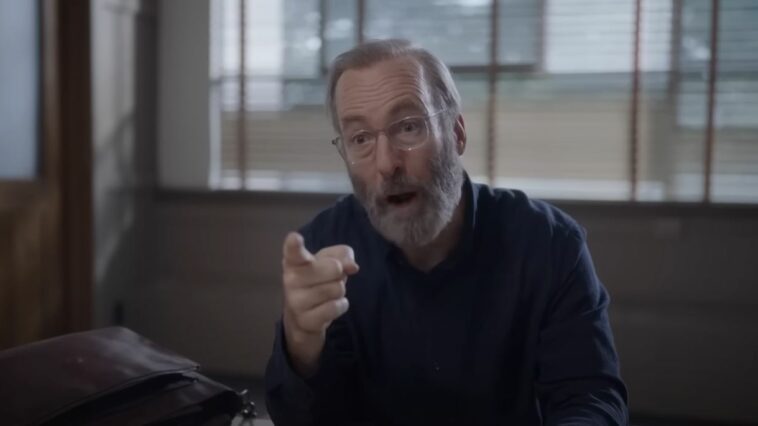 Bob Odenkirk, with glasses and a white beard, points a finger in Lucky Hank